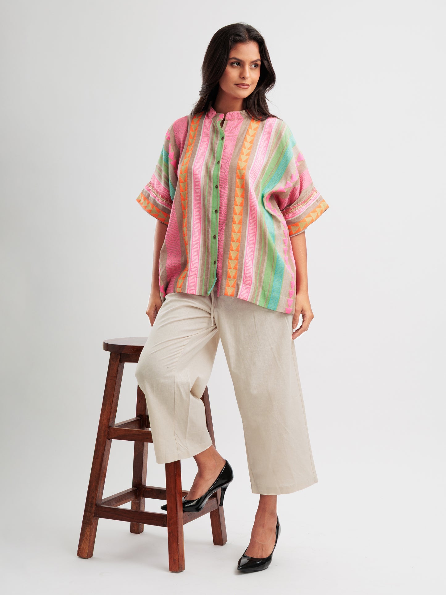 Vibrant striped kaftan shirt with pink, mint, and orange vertical stripes and geometric detailing.