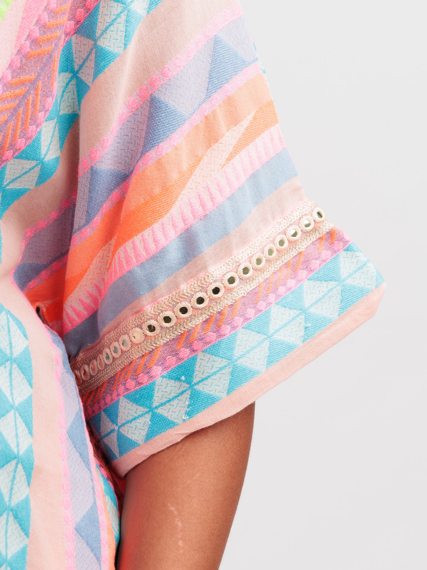 Radiant Rhythm kaftan shirt featuring multicoloured stripes and geometric lace on sleeve details.
