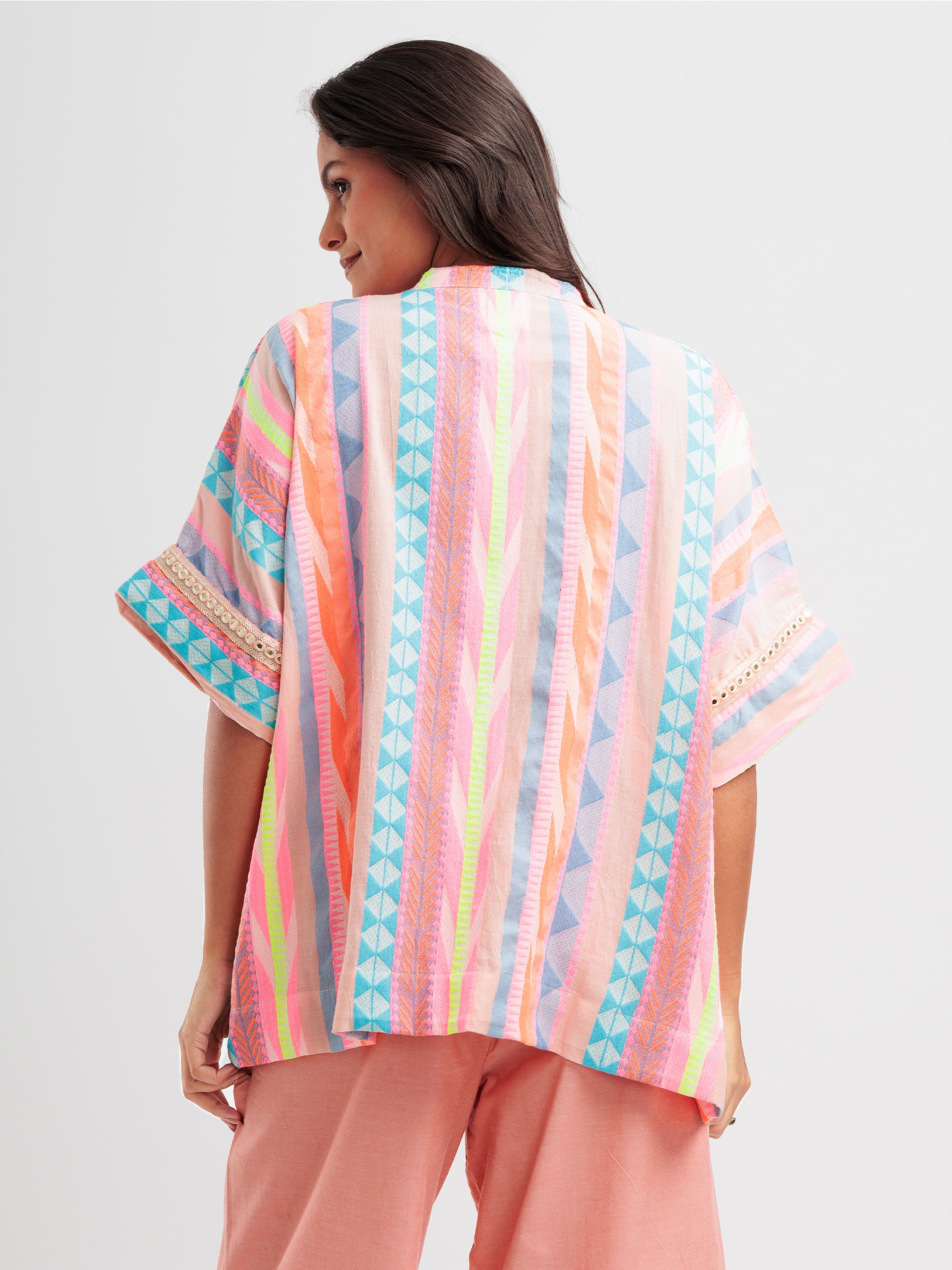 Radiant Rhythm kaftan shirt featuring multicoloured stripes and geometric lace on sleeve details.