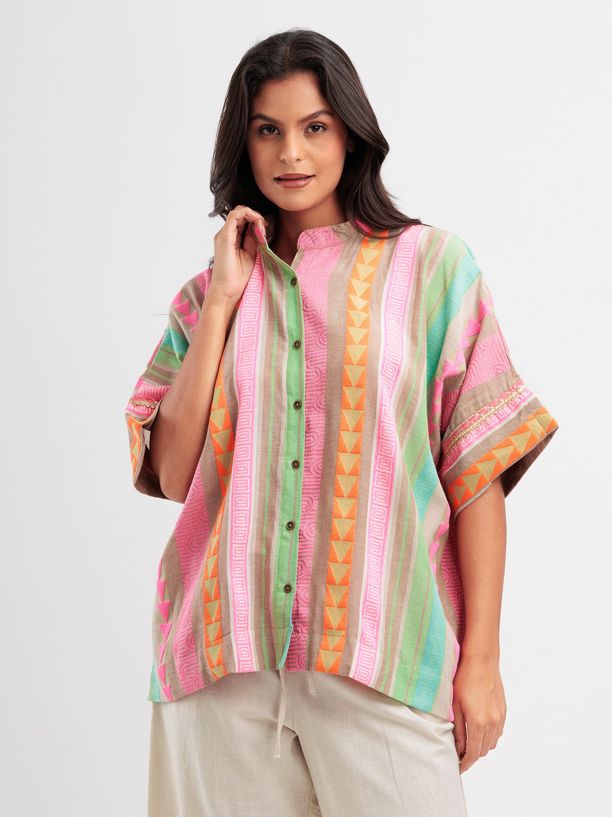 Vibrant striped kaftan shirt with pink, mint, and orange vertical stripes and geometric detailing.