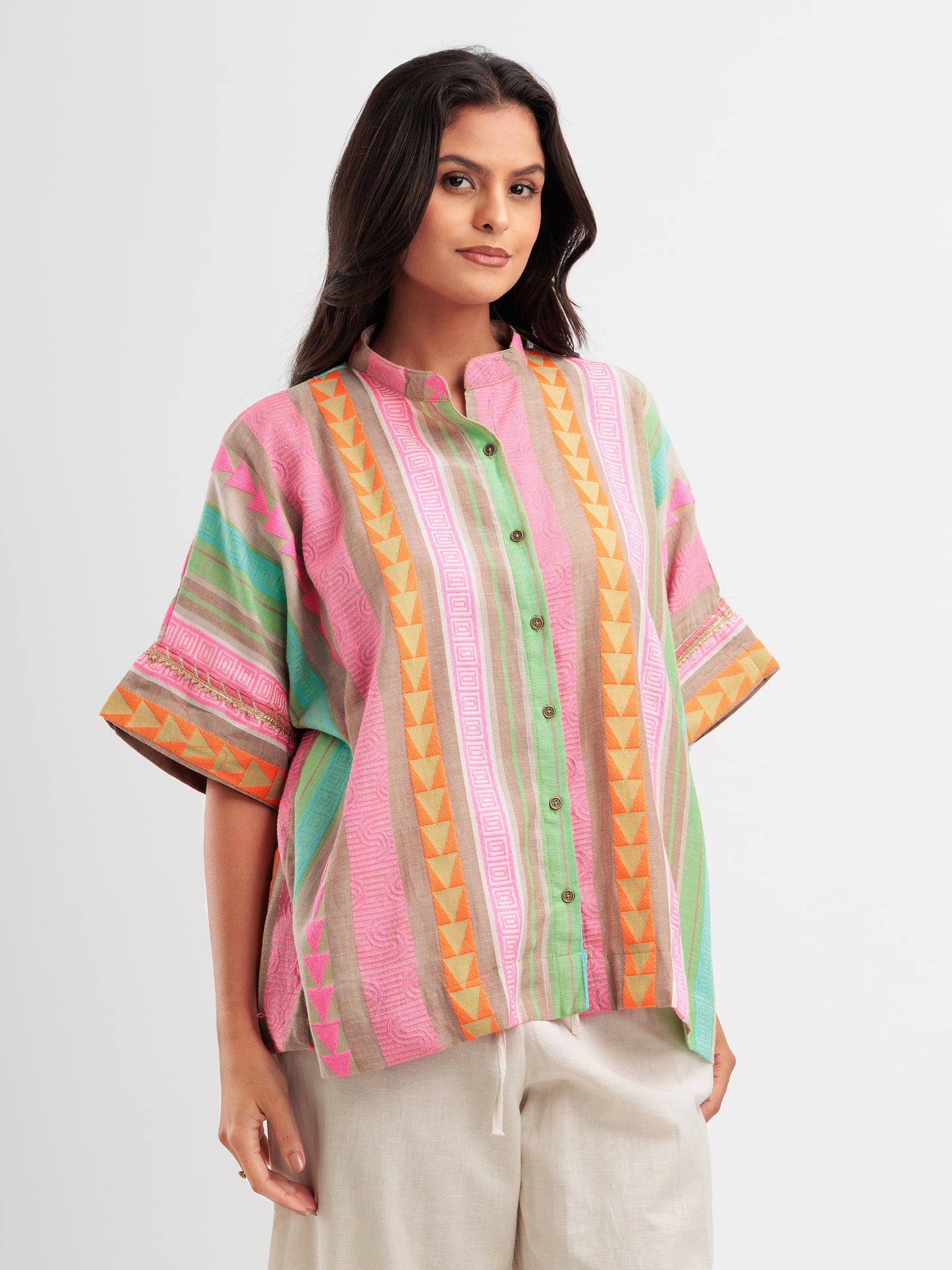 Vibrant striped kaftan shirt with pink, mint, and orange vertical stripes and geometric detailing.