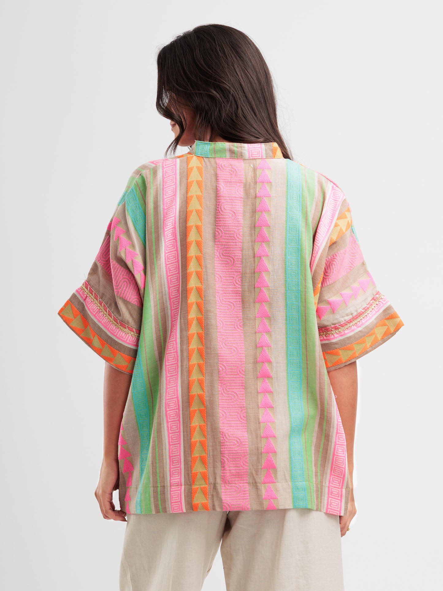 Vibrant striped kaftan shirt with pink, mint, and orange vertical stripes and geometric detailing.